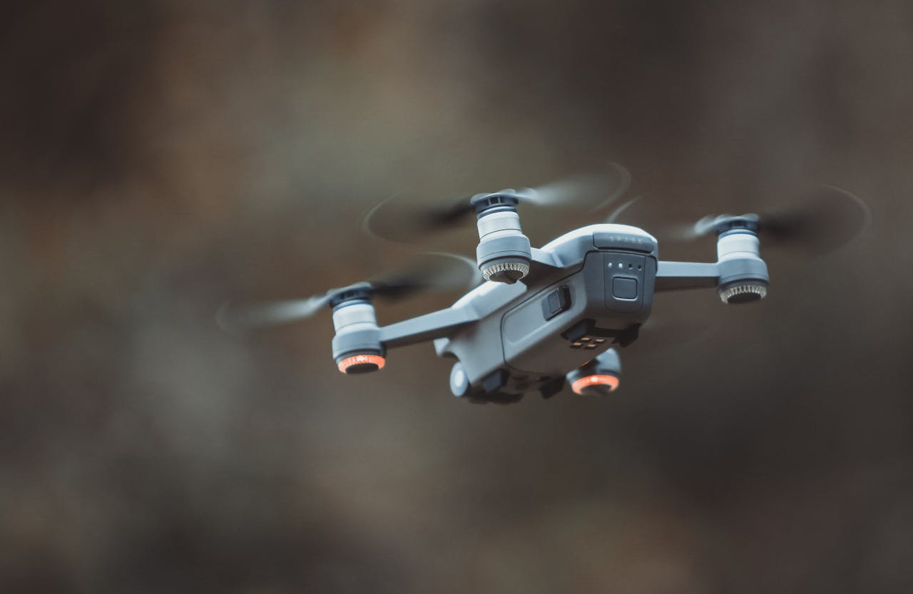 Services-03 A detailed close-up of a drone flying in an outdoor setting, showcasing its design and technology.