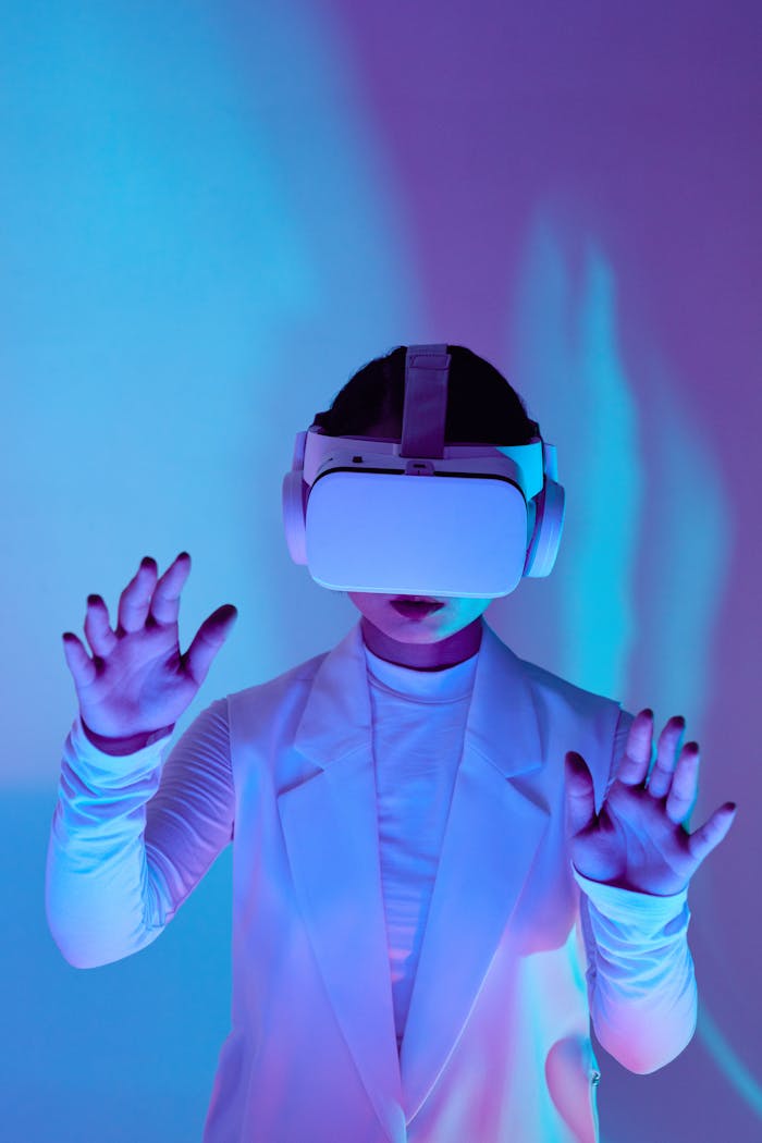Woman in futuristic lighting using a VR headset and gesturing towards the screen.